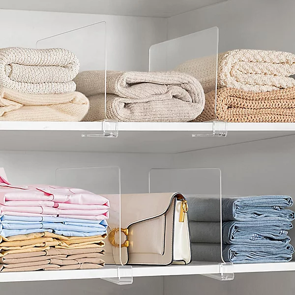 closet shelf dividers organizing folded clothes in small apartment closet