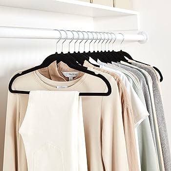 closet organized with slim velvet hangers to maximize space in small apartment